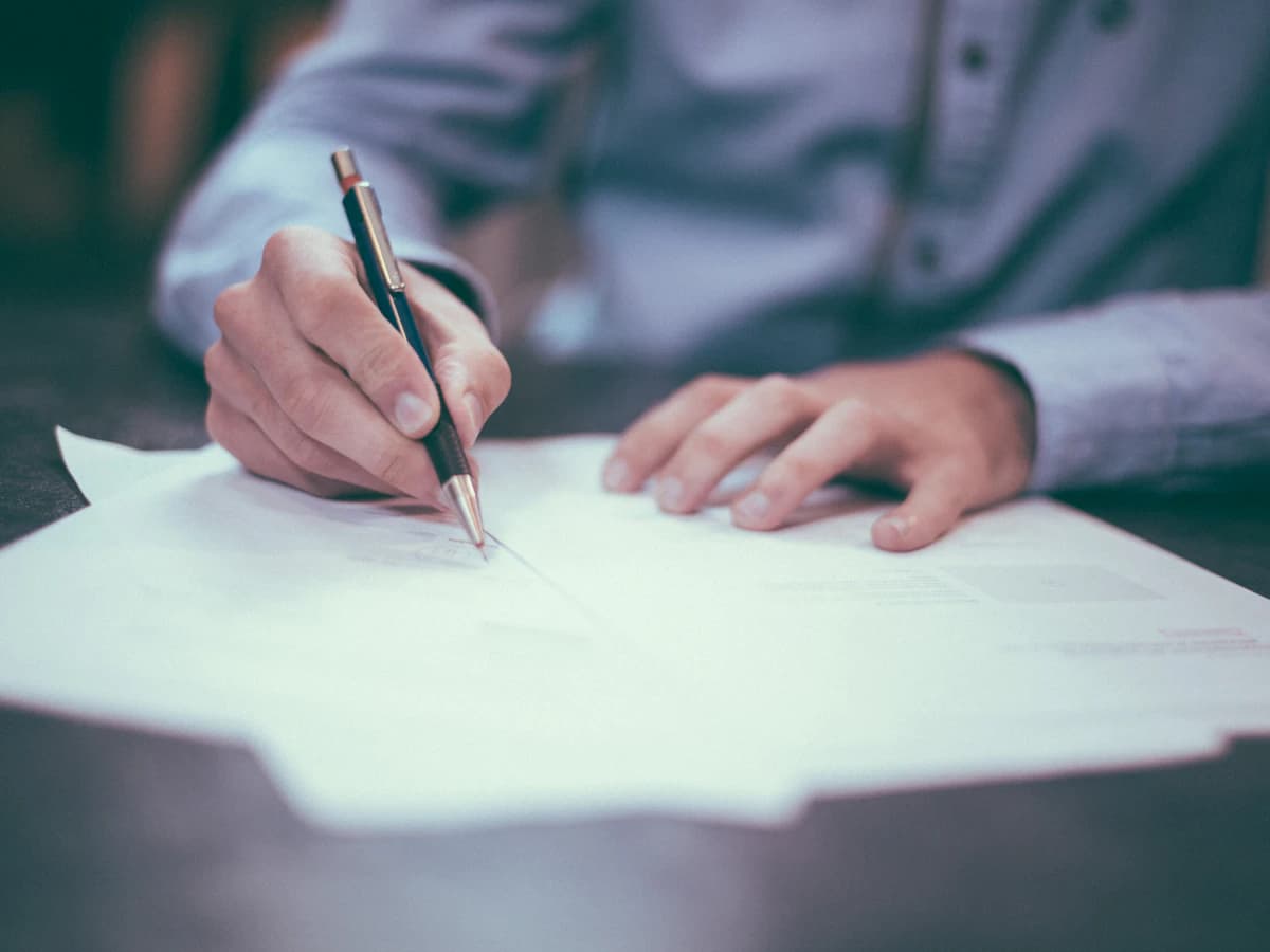 A professional comparing legal-entity and payment-permission information.